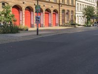 a red stop sign on a city street in front of buildings in europe - style