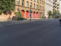 a red stop sign on a city street in front of buildings in europe - style