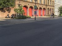 a red stop sign on a city street in front of buildings in europe - style