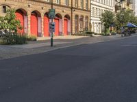 a red stop sign on a city street in front of buildings in europe - style