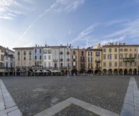 several buildings in a plaza of different colors and sizes and each has a paved courtyard