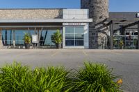 a large building with a clock on the outside of it's front door and grass in front