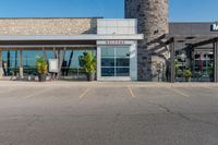 a large building with a clock on the outside of it's front door and grass in front