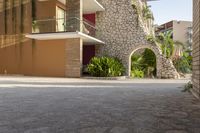 a man is riding a skateboard down the sidewalk in front of an apartment building