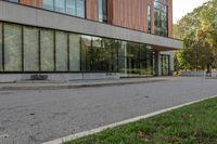 a fire hydrant on the sidewalk beside the building on which the fire hydrant is located