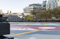 the crosswalk is painted with an array of circles and colors in the city streets