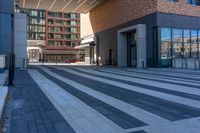 a view down the walkway in front of the building with bicycles parked next to it