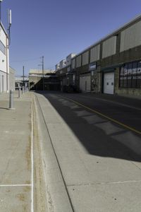 a road and an empty building in a industrial area, showing a wide angle of view