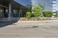 a car drives down the street next to buildings and trees outside of the building,