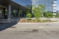 a car drives down the street next to buildings and trees outside of the building,