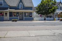 a store is shown on the corner of a street where cars are parked in the street