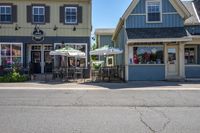 a store is shown on the corner of a street where cars are parked in the street