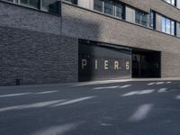 the building is surrounded by concrete and brick walling that says pierre on a black sign