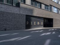 the building is surrounded by concrete and brick walling that says pierre on a black sign