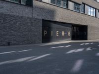 the building is surrounded by concrete and brick walling that says pierre on a black sign