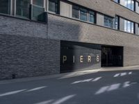 the building is surrounded by concrete and brick walling that says pierre on a black sign