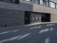 the building is surrounded by concrete and brick walling that says pierre on a black sign