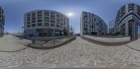 several spherical photos show building in different shapes and sizes in one of them, along with a street as well