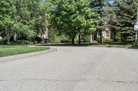 a suburban neighborhood with trees, houses and lawns around the corner of the street