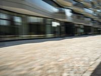 a blurred shot of the cityscape of downtown portland, oregon with cars driving on a street