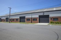 the building has two separate garages with a car garage attached to it's front