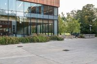 there is a woman riding a skateboard in front of a building outside of it