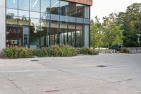 there is a woman riding a skateboard in front of a building outside of it