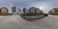 a 360 - cam image of residential building on an empty lot and the buildings are in the background