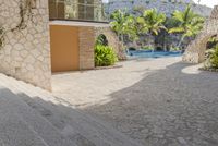 the back patio and pool area is filled with steps leading to a large patio area