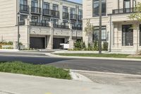 a man is riding his bike down a street near an apartment building in toronto, canada