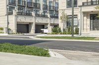 a man is riding his bike down a street near an apartment building in toronto, canada