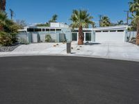 A Residential Building Surrounded by Palm Trees and Clear Skies