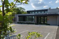 a building with trees surrounding it, and there is no image here to provide a caption for