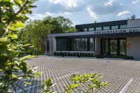 a building with trees surrounding it, and there is no image here to provide a caption for