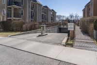 the concrete is exposed on one side of the road and has an entrance to it, leading to buildings behind