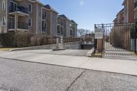 the concrete is exposed on one side of the road and has an entrance to it, leading to buildings behind