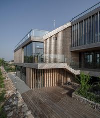 a building that has stairs leading to the outside area of it and wooden floors and ceilings