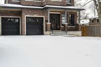 a large brown brick home in the snow with trees in front of it and the driveway covered with snow
