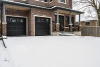 a large brown brick home in the snow with trees in front of it and the driveway covered with snow