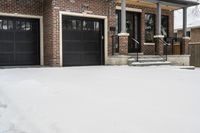 a large brown brick home in the snow with trees in front of it and the driveway covered with snow