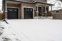 a large brown brick home in the snow with trees in front of it and the driveway covered with snow