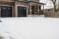 a large brown brick home in the snow with trees in front of it and the driveway covered with snow