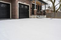 a large brown brick home in the snow with trees in front of it and the driveway covered with snow