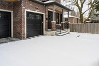 a large brown brick home in the snow with trees in front of it and the driveway covered with snow