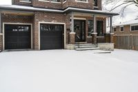 a large brown brick home in the snow with trees in front of it and the driveway covered with snow