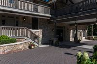 the entrance to the large brown building with lots of stone walls and stairs leading up to the front door