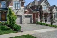 a home with two garages and a tree in the front yard at a residential in toronto, ontario