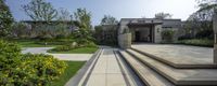 a house is shown with steps in the front and back garden on both sides, and green landscaping around the entry way