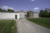 an image of a house from the side in a park setting on a sunny day