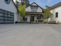 a house that has a large driveway in front of it that's surrounded by trees